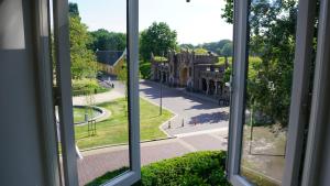 een raam met uitzicht op een gebouw bij Room One-Twenty-One in Naarden