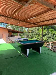 a pool table sitting under awning on a patio at Recanto tia tonha in Guaramiranga +8 photos