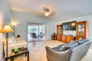 a living room with a couch and a table at 4 Mi to Beaches Fort Myers Escape with Patio in Fort Myers