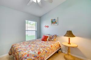 a bedroom with a bed with a lamp and a window at 4 Mi to Beaches Fort Myers Escape with Patio in Fort Myers +21 photos
