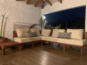 un sofá en una sala de estar con almohadas en Los laureles limache, 