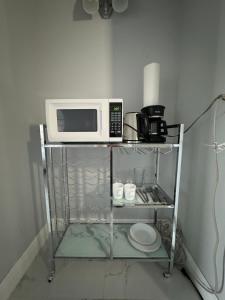 a microwave oven sitting on top of a shelf at Spacious Apt Ocean Reserve Resort Amenities in Sunny Isles Beach