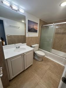 a bathroom with a sink and a toilet and a shower at Spacious Apt Ocean Reserve Resort Amenities in Sunny Isles Beach