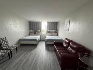 a living room with two beds and a couch at Spacious Apt Ocean Reserve Resort Amenities in Sunny Isles Beach +109 photos