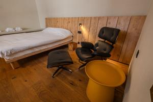 a room with a bed and two chairs and a desk at Central Square Apartments - Центральна площа міста in Chernivtsi