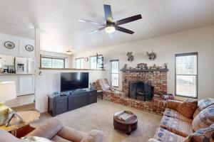 un soggiorno con camino e ventilatore a soffitto di Lazy Bear Cabin #554 a Big Bear Lake