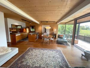 a living room with a table and a dining room at Mountains & Lake Boutique Apartment in St. Wolfgang