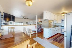 a kitchen and dining room with white cabinets and a table at Lazy Bear Cabin #554 in Big Bear Lake