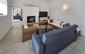 a living room with a couch and a fireplace at Beautiful Home In Pordic With Wifi in Pordic