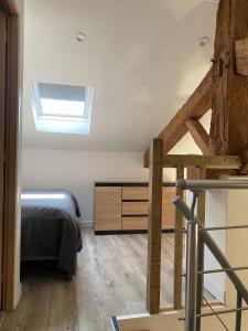 a bedroom with a bed and a skylight at L'orangerie in Seignosse