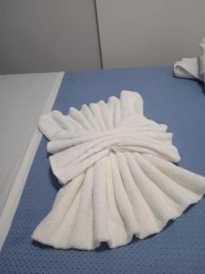 a pile of white towels on a blue floor at Villa Porto fossa 2 in Marzamemi