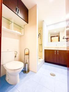 a bathroom with a toilet and a sink at Little Palmar with Free Parking & Pool & Padel in Palm-Mar