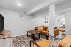a living room with a couch and a table at Sweet & Cozy Studio Apartment in South Burlington