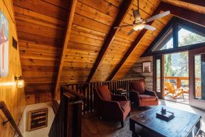 a living room with wooden walls and a ceiling at The Refugio #2552 in Big Bear Lake