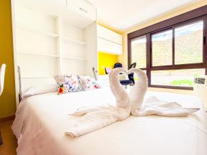 a bed with two swans made out of towels at Little Palmar with Free Parking & Pool & Padel in Palm-Mar