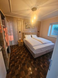 a bedroom with a large bed and a wooden floor at Villa Lena in Ohrid