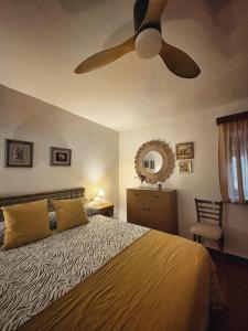 a bedroom with a bed with a ceiling fan at Casa Celia in Miranda del Rey