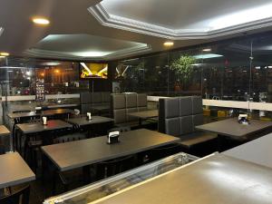 a dining room with tables and chairs in a restaurant at Gran hotel teatro in Manaus