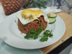 a plate of food with a fried egg on top at Ocean Bloom Villa in Trincomalee
