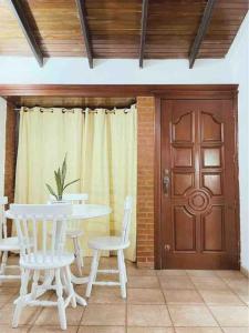 a dining room with a table and chairs and a door at Casa de Huespedes in Maturín +9 photos