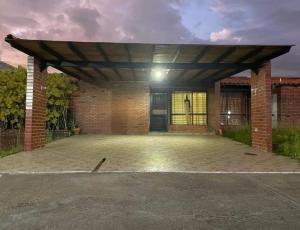 a garage with awning on top of a brick building at Casa de Huespedes in Maturín