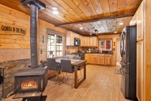 a kitchen with a woodburning stove and a table with chairs at Lily's Bear Cabin #2544 in Big Bear Lake