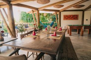 a dining room with a table and pool tables at T Tree Luxury Villa in Pipa