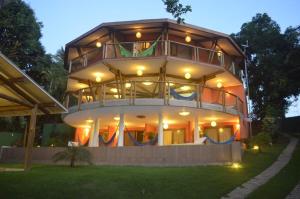 a large building with lights on the front of it at T Tree Luxury Villa in Pipa