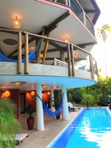 a house with a swimming pool next to a building at T Tree Luxury Villa in Pipa