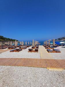 a beach with chairs and umbrellas and the ocean at Private Villa with Pool - Utjeha Hills in Utjeha