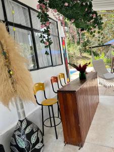 a room with a counter with chairs and a vase at cabaña vacacional prado tolima in Prado