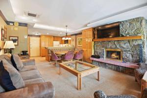 a living room with a couch and a fireplace at Lodge Tower 594 One Bedroom Residence in Vail