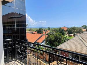 a balcony with a view of a building at Zion Apartments in Bwebajja