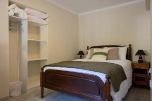 a bedroom with a bed in a room with shelves at Azorean Stays T1-Relaxing 1-Bedroom Retreat Near São Miguel Highlights in Lomba da Cruz