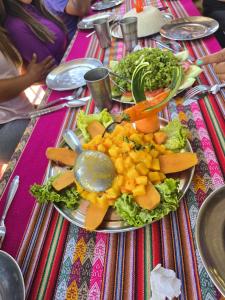a plate of food with vegetables on a table at Chaullay Star Domes in Colcapampa