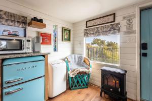 a kitchen with a stove and a microwave at Ashley's Treehouse At El Mistico Ranch in Nogal