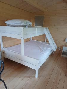 a white bunk bed in a wooden room at Búdardalur glamping in Búðardalur