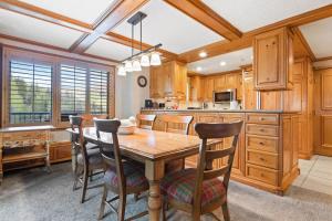 a large kitchen with a wooden table and chairs at Lodge Tower 599 One Bedroom Residence in Vail +11 photos