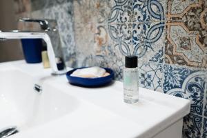 a bottle of water sitting on a sink in a bathroom at Dimora Domitia - Apartments in Mondragone +125 photos