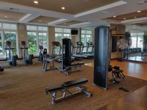 a gym with a lot of treadmills and machines at Modern Bedroom In Great Condo! Beach Pass Incl! in Boynton Beach