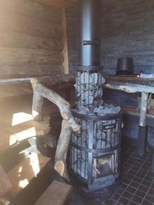 a wood fired stove in a log cabin at Villa Karhukumpu in Ivalo +61 photos