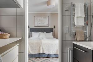 a small bedroom with a bed and a sink at KAI studio in Karlskrona