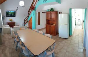 a dining room with a table and a refrigerator at Casa 4 VLG in Las Grutas