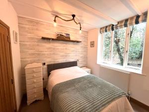a bedroom with a bed and a wooden wall at Cromer Getaway luxury apartment in Cromer