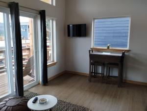 a living room with a desk and a window at Lupine Cabin - Homer Seaplane Base in Homer