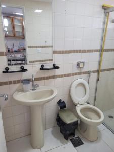 a bathroom with a toilet and a sink at Apartamento Caldas Novas in Caldas Novas
