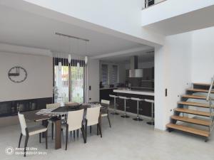 a dining room and kitchen with a table and chairs at Villa Anastasia in Psinthos