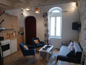 a living room with a couch and chairs and a table at Patrika Traditional House in Patriká