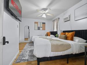 a bedroom with two beds and a ceiling fan at Boston 4BR Home with Parking BBQ Fire in Somerville