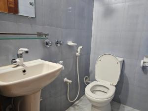 a bathroom with a toilet and a sink at Hotel City International Residential Panthapath in Dhaka +28 photos